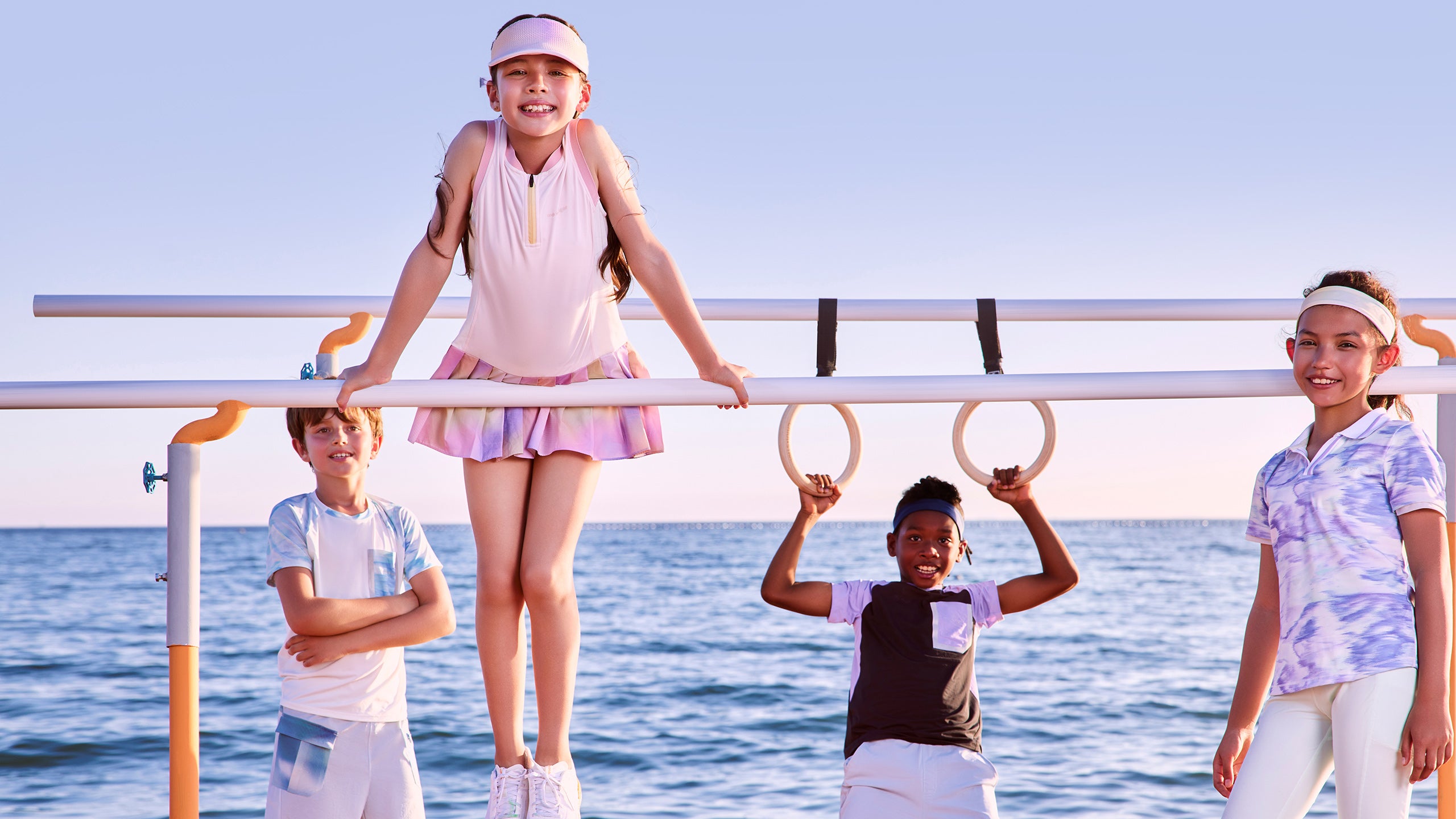 Children standing on a boat with a clear blue sky and ocean background
